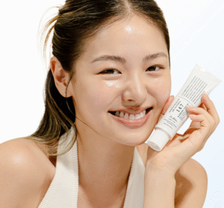 Smiling woman holding Dr. Althea 147 Hypoallergenic Cream for sensitive skin